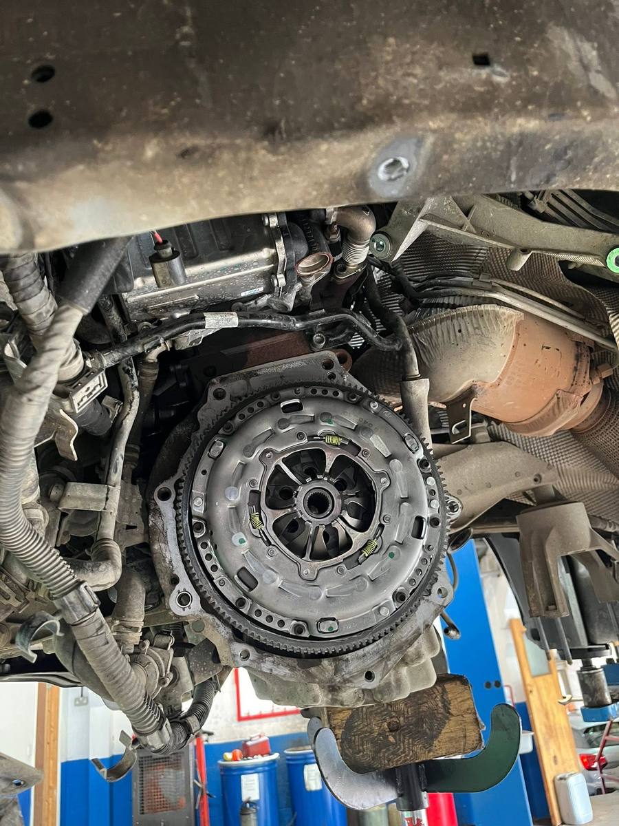 New clutch and flywheel on the car with the gearbox removed